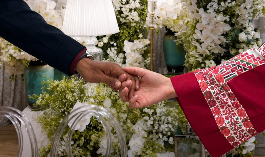 Ahmed and Jannah holding hands before the orchid wall at Kamalinda Events & Weddings